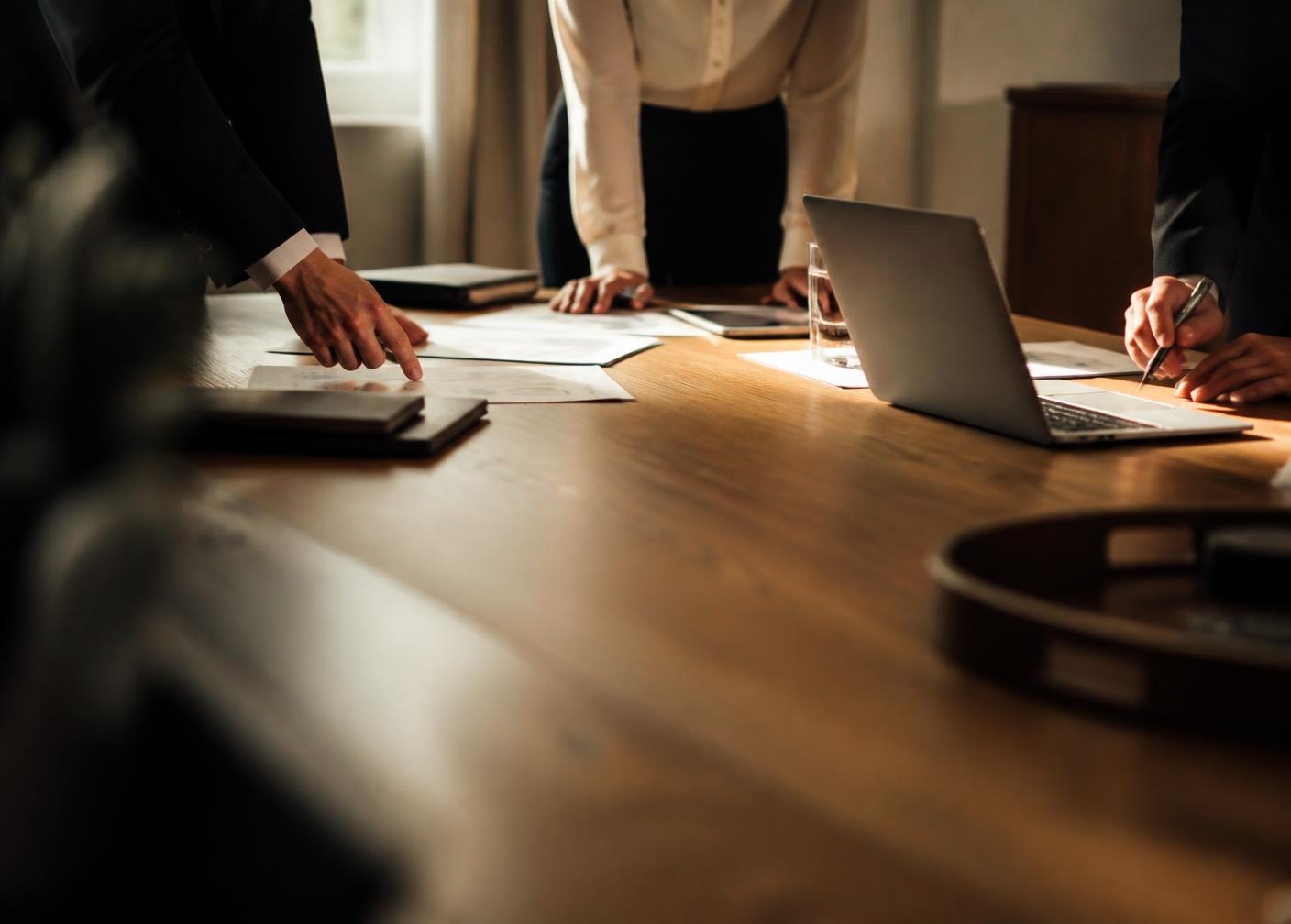 A small executive strategy session around a table